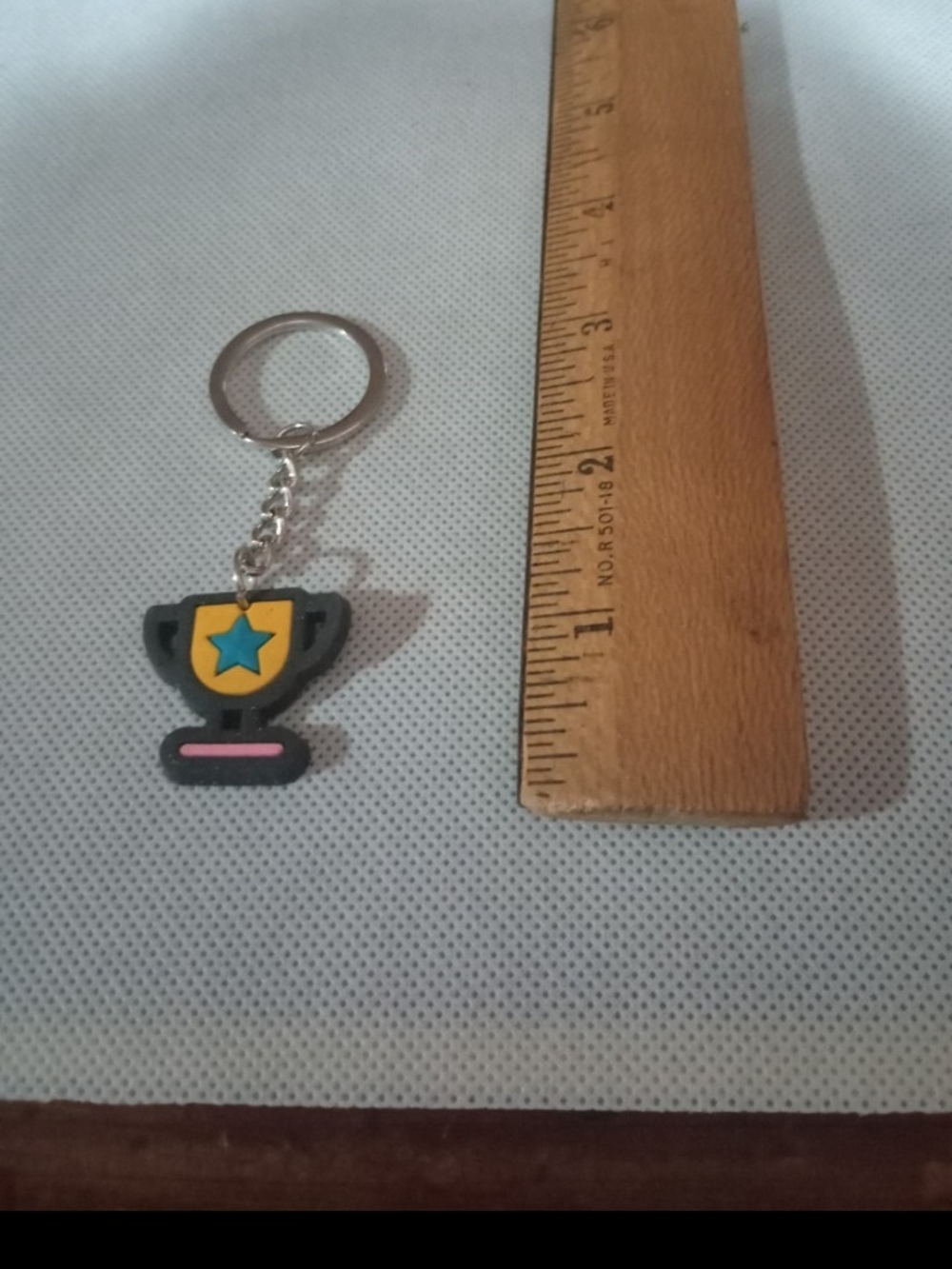 Black Trophy Keychain with Yellow Shield and Blue Star